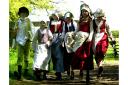 Children set off to work around the farm at a Kentwell Hall Tudor weekend event in 2003