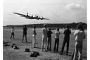 A crowd watching as a B-17 does a low fly-by at Woodbridge Air Show in 1976