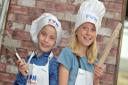 Hannah and Phoebe have a go at cooking  Picture: SARAH LUCY BROWN