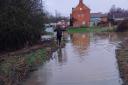 People have been pictured wading through floods