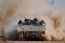 An Israeli armoured personnel carrier moves near the Gaza Strip border in southern Israel (Tsafrir Abayov/AP)