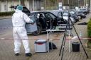 A forensics officer works near a car in front of the Von D’ring barracks in Rotenburg, Germany, on Friday after four people were killed in shootings in northern Germany (Sina Schuldt/dpa via AP)