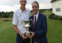 Gregor Tait receives the Seaton Robson Trophy from Aldeburgh club captain Antony Dearden. Photograph: TONY GARNETT