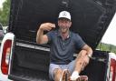 Lee Dinmore sits in the boot of his newly-won £50,000 Mercedes truck. Picture: CONTRIBUTED
