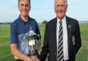 Conal Downing receives the F W Mackenzie Cup from Suffolk Golf Union president Colin Firmin after winning the Suffolk Junior Championship. Picture: TONY GARNETT
