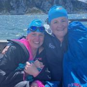 Two university friends embarked on a 15 hour two-person relay swim across the channel in honour of friends lost to bowel cancer.