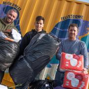 Just some of the items dropped in to Mannings in Felixstowe for people in Ukraine. L-R Charlie Manning, Lorenzo Bertola, Jonny Manning. Picture: Sarah Lucy Brown