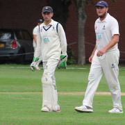 Sudburys Adam Mansfield, left, talks to all-rounder Michael Comber during the match against Lincolnshire at Ipswich School during which he equalled a county record of making 37 dismissals in a season for Suffolk Photograph: NICK GARNHAM