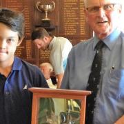 Thirteen-year-old Dominic Rudd receives the Silver Frigate from Thorpeness club captain Robin Leggate. Photograph: CONTRIBUTED